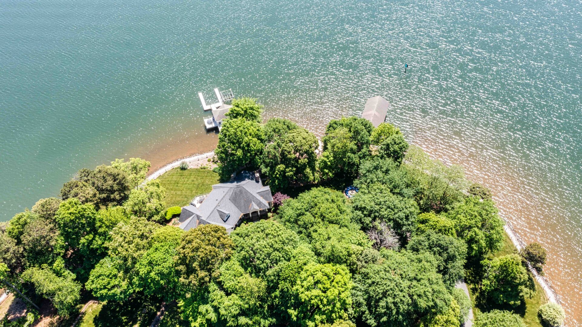 A house sitting on top of a tree near the water.