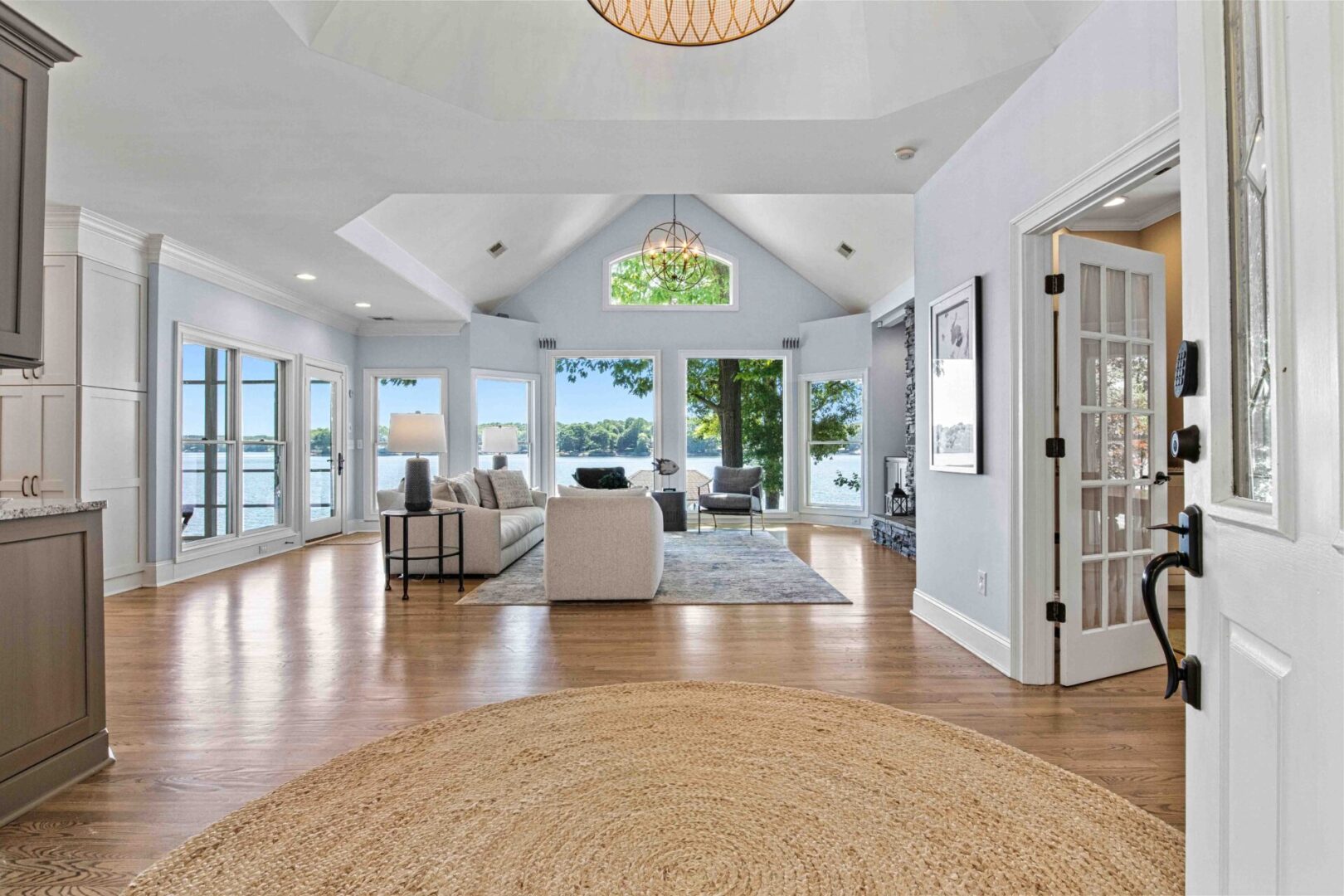 A large open living room with hard wood floors.