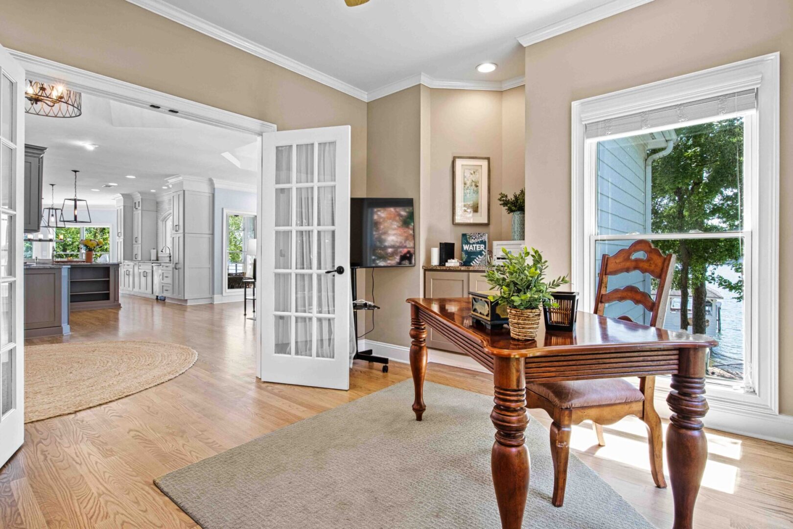 A living room with hard wood floors and white walls.