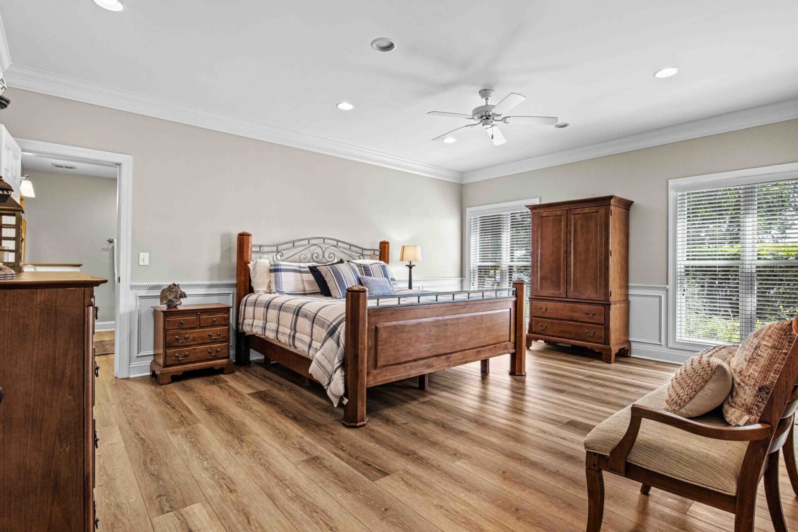 A bedroom with hard wood floors and furniture.