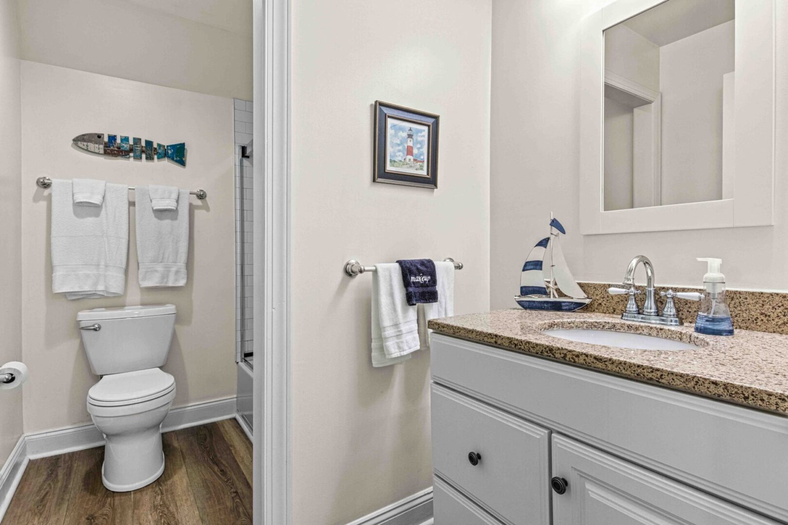 A bathroom with white cabinets and a toilet.