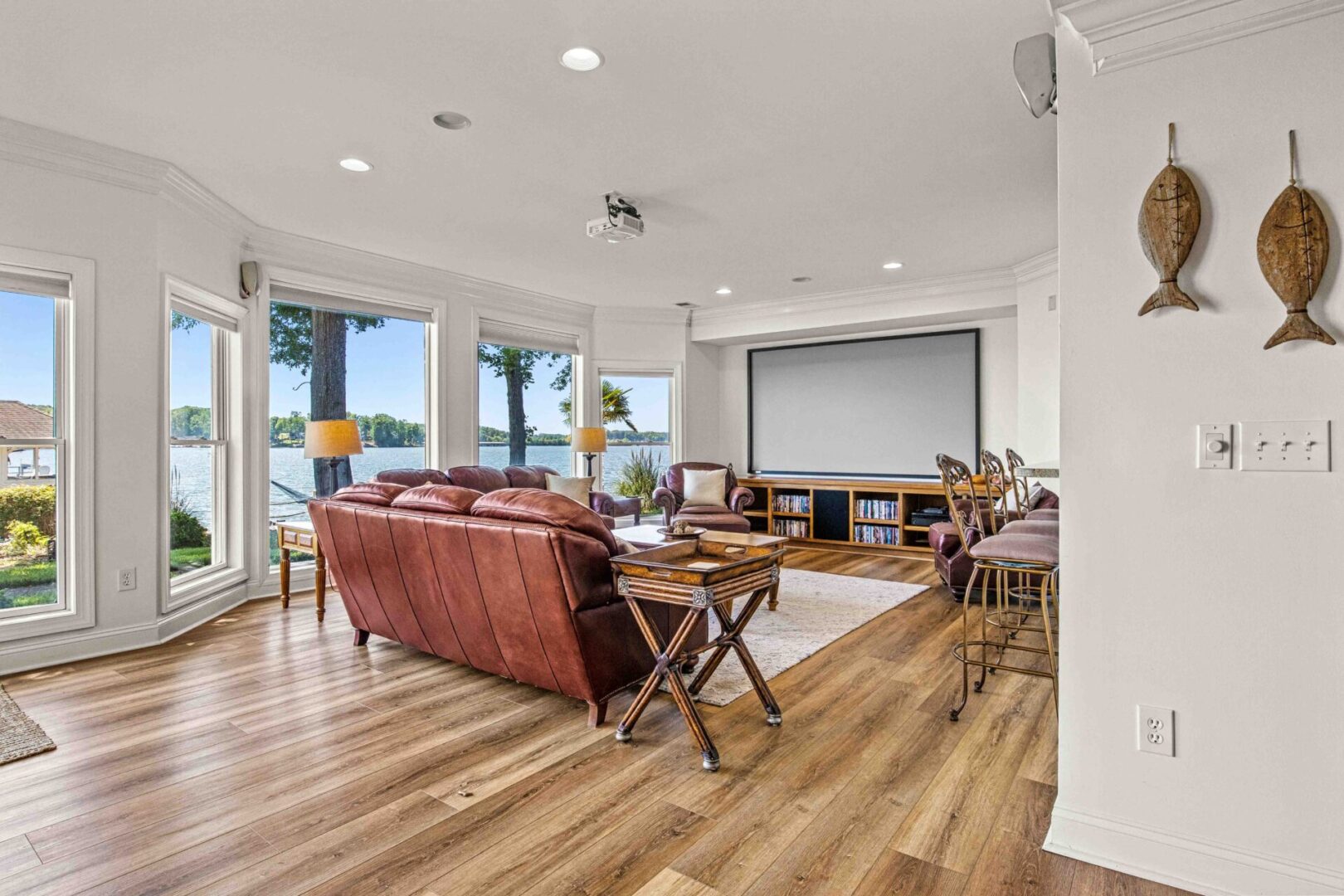 A living room with wood floors and large windows.