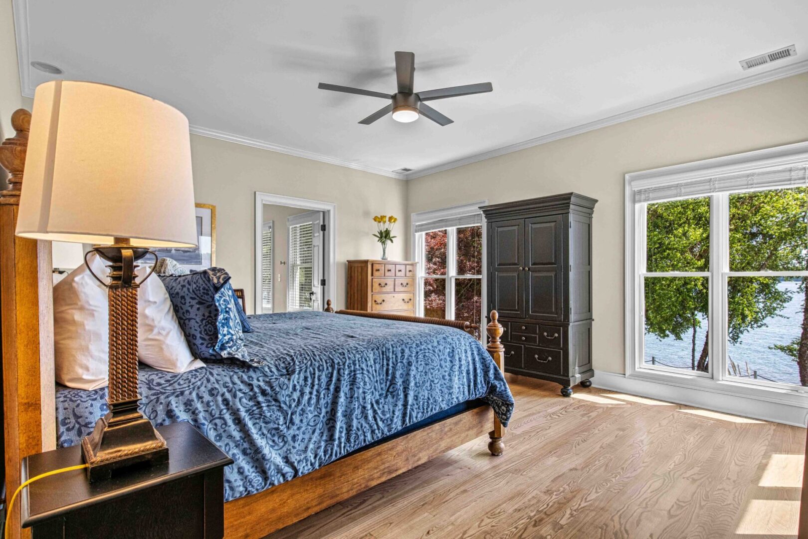 A bedroom with a bed, dresser and window.