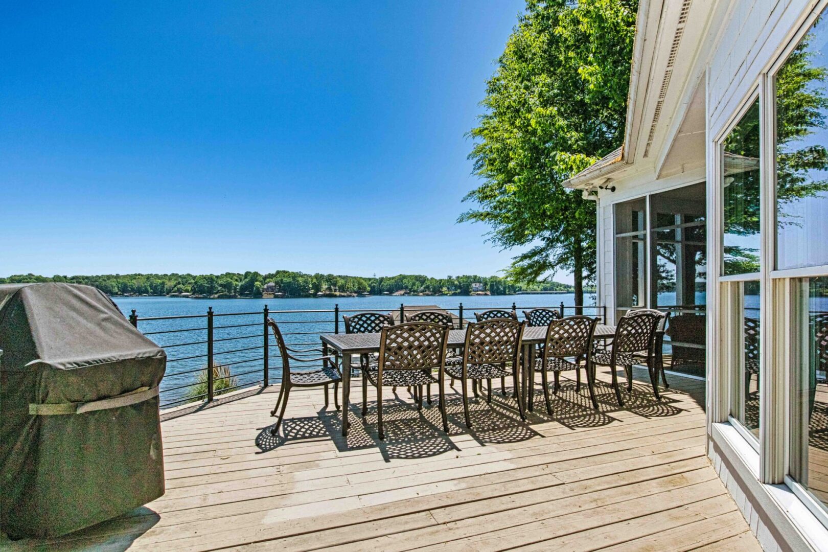 A large deck with chairs and tables on it