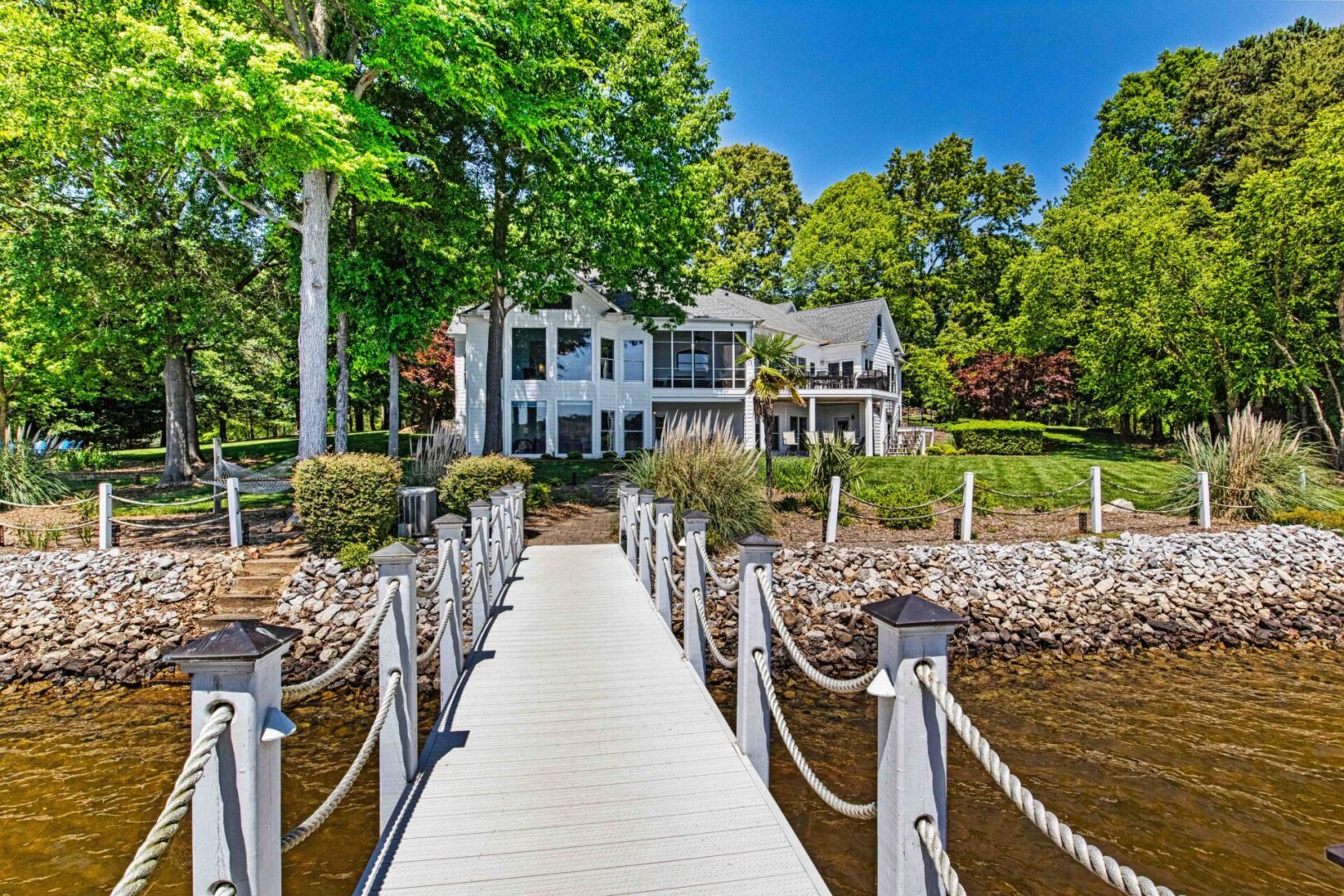 A dock with a house in the background