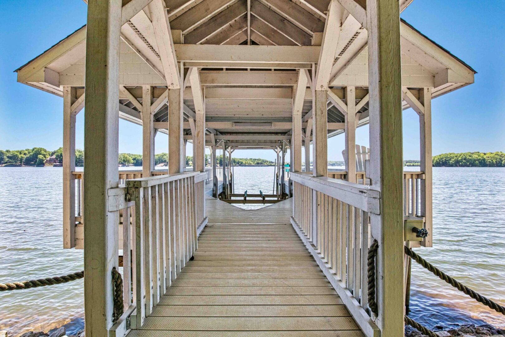 A wooden walkway with a view of the water.